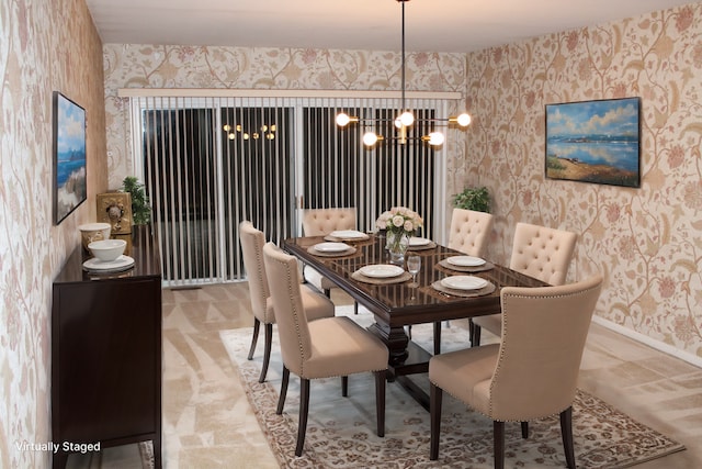 dining space with wallpapered walls, baseboards, and a chandelier