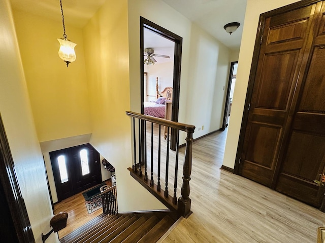 foyer with light wood-style floors and baseboards