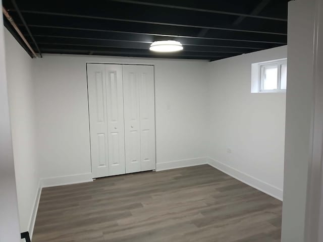 below grade area with wood finished floors and baseboards