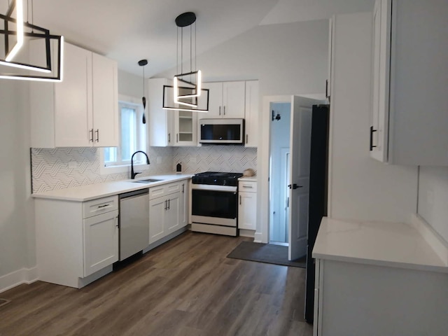 kitchen featuring decorative backsplash, white cabinets, a sink, gas range, and dishwasher