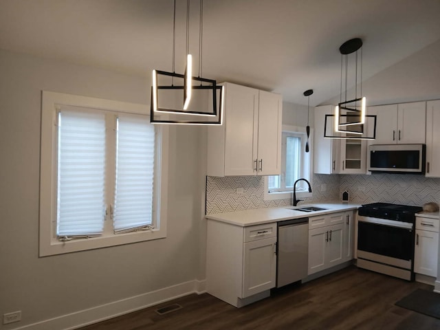 kitchen featuring stainless steel appliances, visible vents, a sink, and white cabinetry