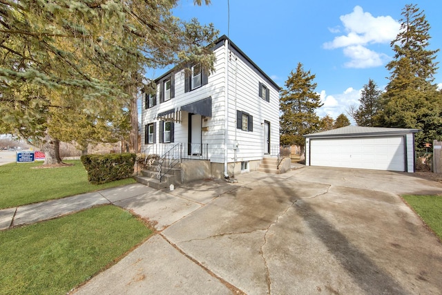 view of front of home featuring a garage, a front yard, and an outdoor structure