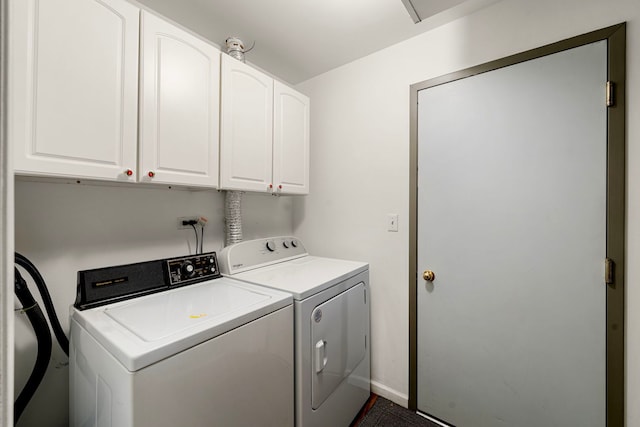 clothes washing area with cabinet space, baseboards, and washer and clothes dryer