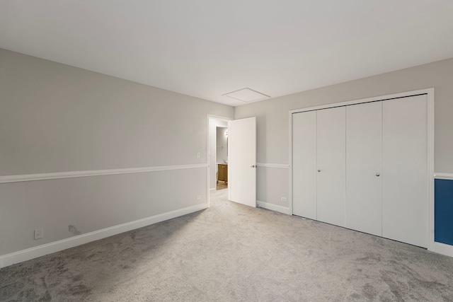 unfurnished bedroom with carpet floors, baseboards, and a closet