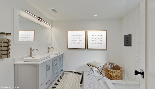 bathroom with recessed lighting, visible vents, a sink, and double vanity