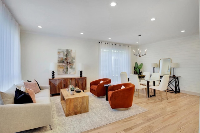 living room featuring a chandelier, recessed lighting, and light wood-style floors