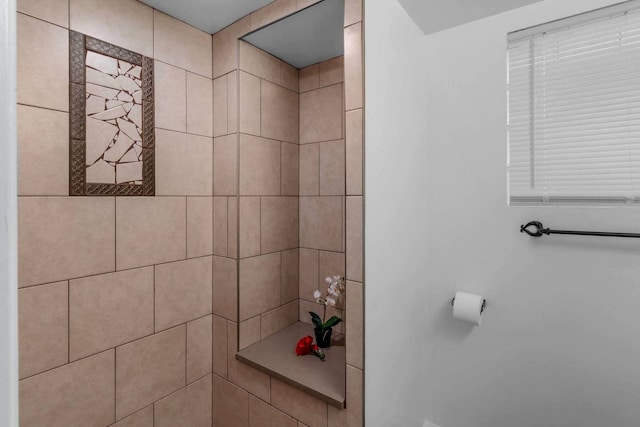 full bath with tiled shower