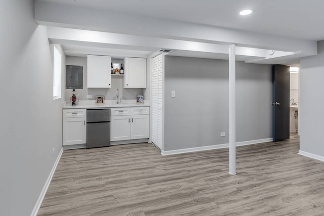 bar featuring visible vents, baseboards, fridge, electric panel, and light wood finished floors