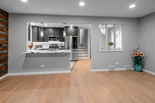 kitchen featuring light wood finished floors, visible vents, appliances with stainless steel finishes, and light countertops