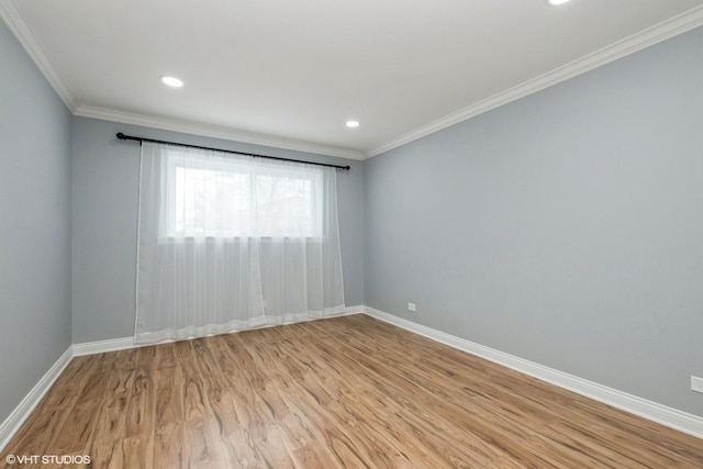 empty room featuring light wood-style flooring, ornamental molding, baseboards, and recessed lighting