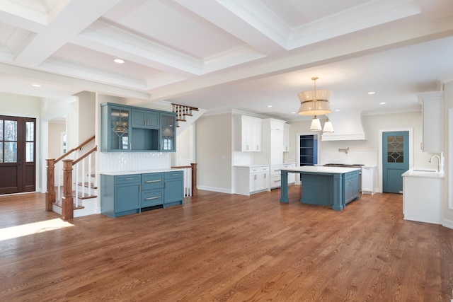 kitchen with blue cabinetry, beamed ceiling, and dark wood finished floors