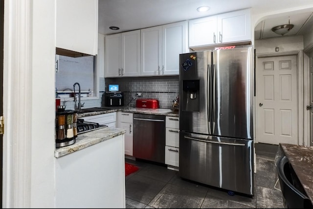 kitchen with white cabinets, a sink, dishwasher, and stainless steel fridge with ice dispenser