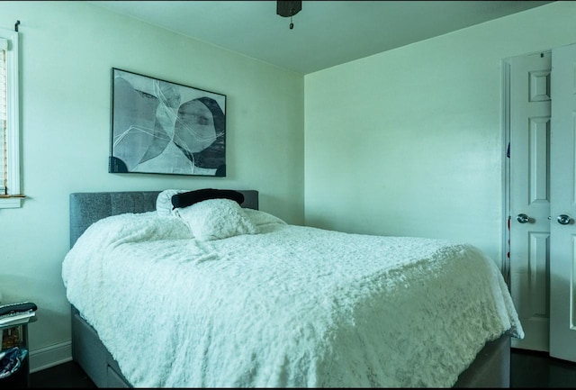 bedroom featuring ceiling fan and baseboards