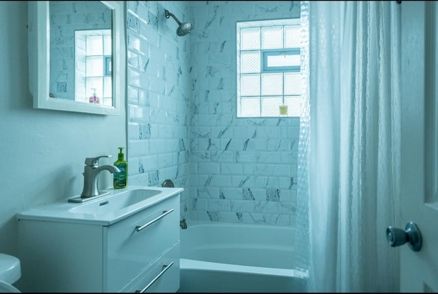 full bath with toilet, shower / bath combination with curtain, and vanity