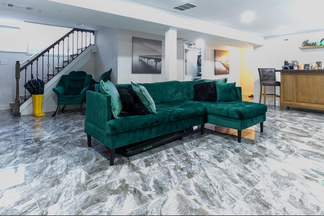 living room with marble finish floor, stairs, and visible vents