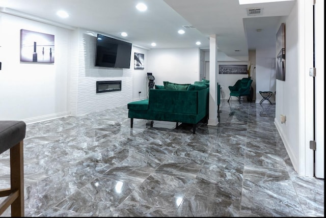 interior space featuring marble finish floor, recessed lighting, visible vents, a glass covered fireplace, and baseboards