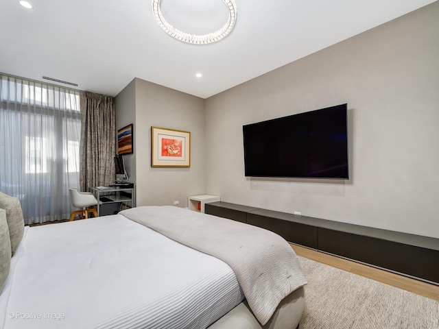 bedroom featuring wood finished floors and recessed lighting