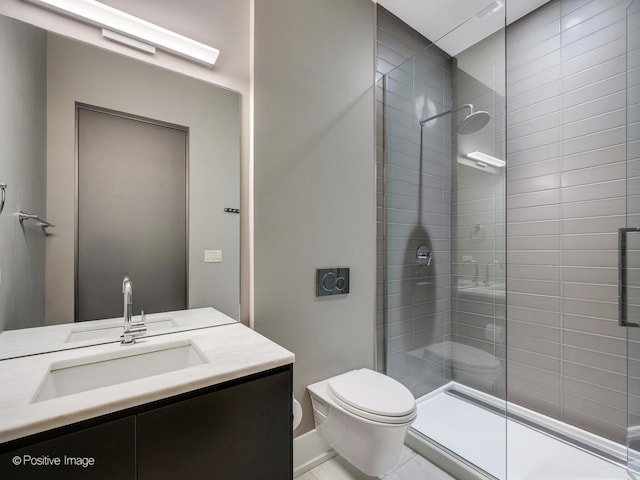 bathroom with toilet, tiled shower, and vanity