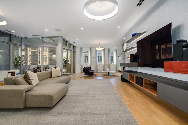 living room with recessed lighting, visible vents, and light wood-style flooring