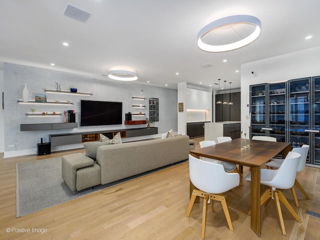 dining room featuring light wood-type flooring and recessed lighting