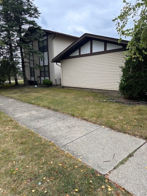 view of home's exterior with a yard