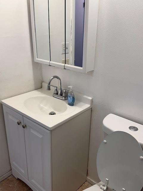 bathroom with toilet and vanity