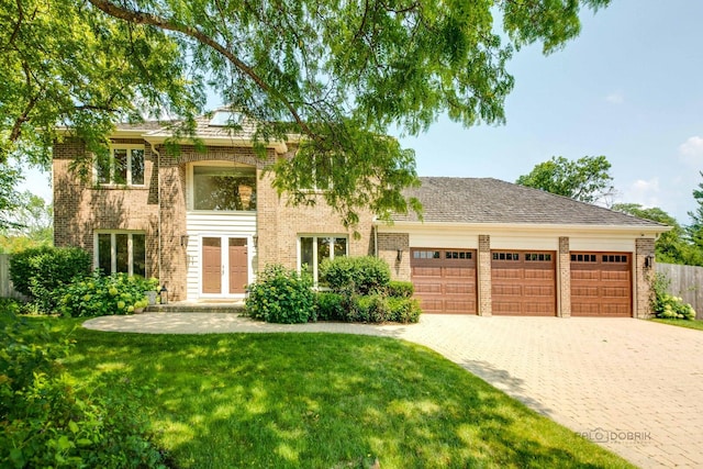 view of front of house with a garage, decorative driveway, brick siding, and a front lawn