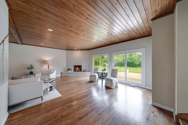 living area with a high end fireplace, wood ceiling, baseboards, and wood finished floors