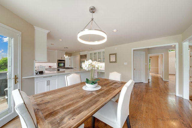 dining space with baseboards, recessed lighting, and light wood-style floors