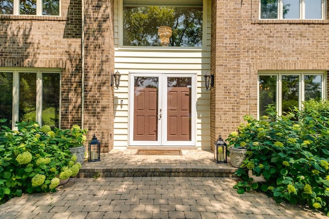 entrance to property featuring brick siding