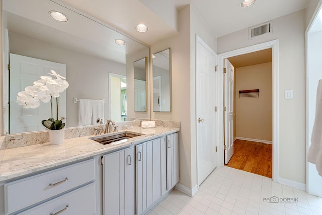 bathroom featuring recessed lighting, visible vents, baseboards, and vanity