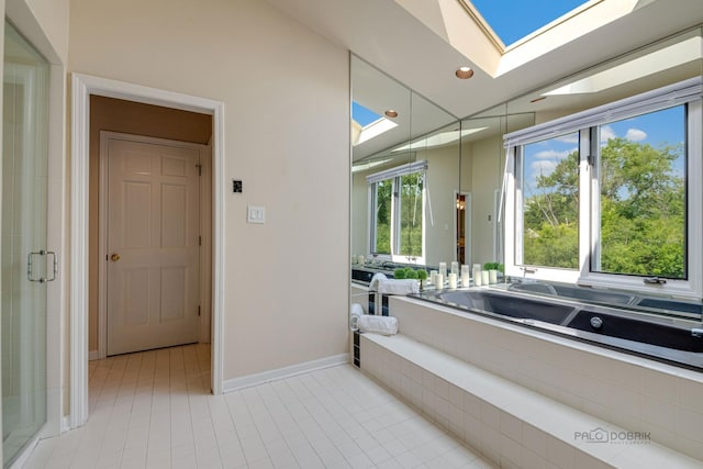 full bath featuring lofted ceiling with skylight, recessed lighting, tile patterned flooring, and a stall shower