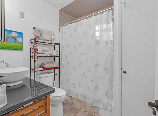 bathroom with a shower with shower curtain, vanity, toilet, and tile patterned floors