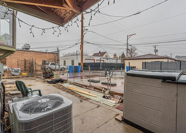 view of patio / terrace with central air condition unit and fence