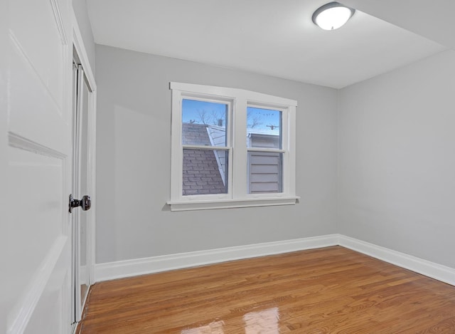 unfurnished room with light wood finished floors and baseboards