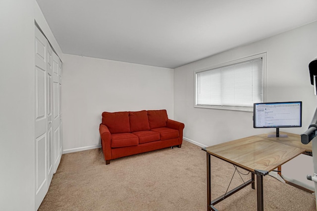 home office featuring light carpet and baseboards