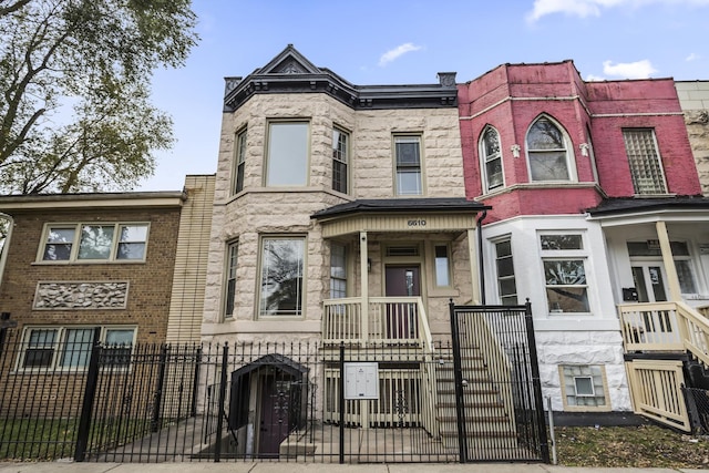 view of property featuring a fenced front yard and a gate