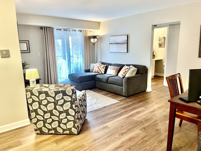 living room with light wood-style flooring and baseboards