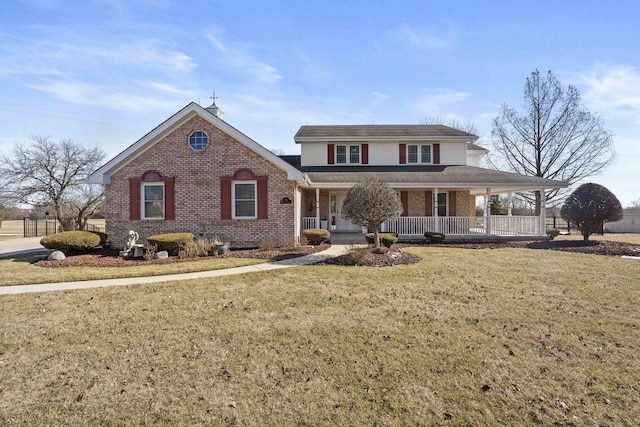 view of front of property with brick siding, a front lawn, and a porch