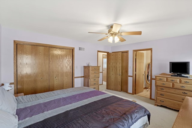 bedroom featuring light colored carpet, visible vents, and ceiling fan