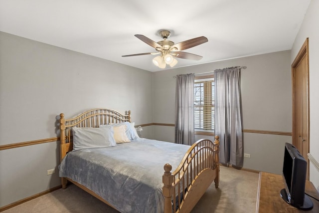 bedroom with ceiling fan, carpet flooring, and baseboards