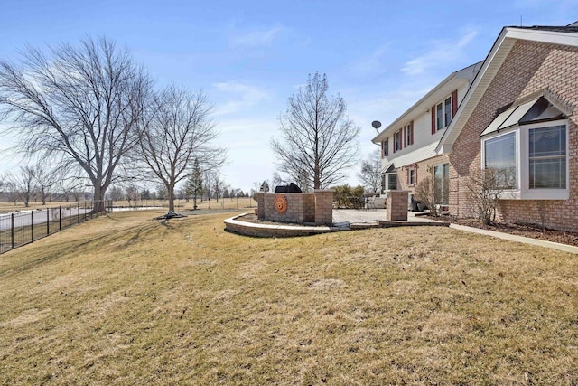 view of yard featuring fence and a patio