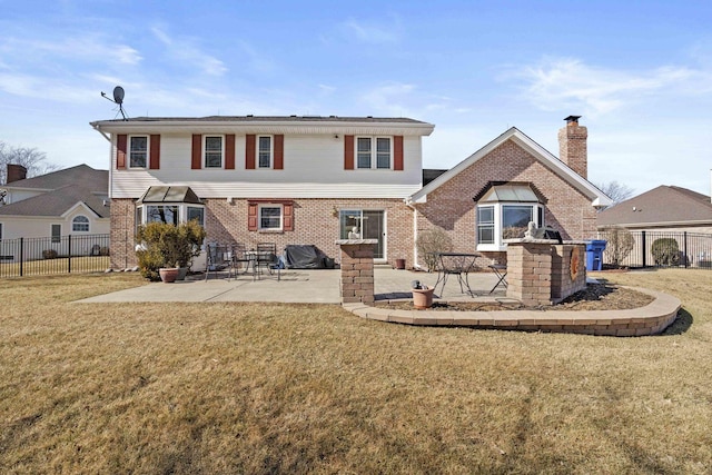 rear view of property featuring a patio area, brick siding, and fence