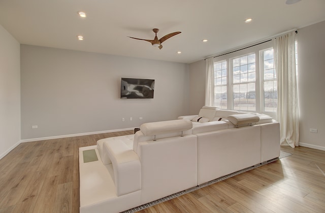 living area with light wood-style floors, recessed lighting, baseboards, and a ceiling fan