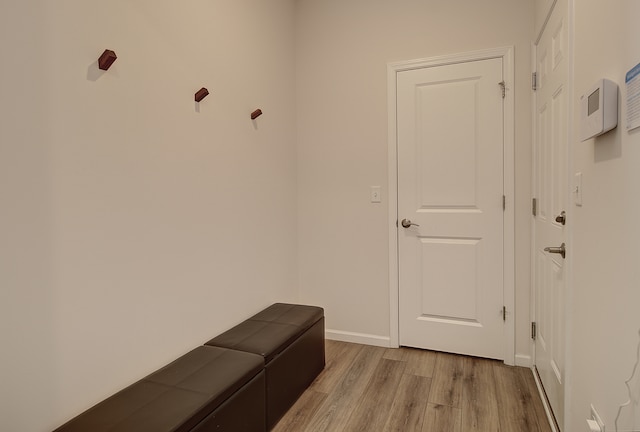 mudroom with light wood-style flooring and baseboards