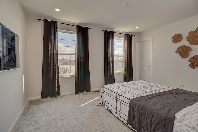 bedroom featuring baseboards, recessed lighting, and light colored carpet