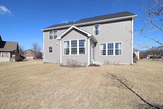 back of house featuring a lawn