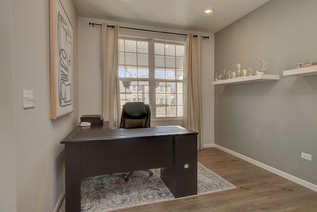 office featuring baseboards, wood finished floors, and recessed lighting