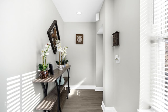 hall with baseboards, wood finished floors, and recessed lighting