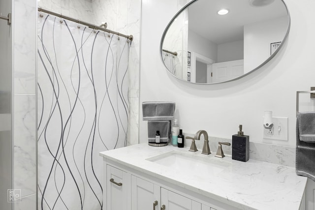 bathroom with curtained shower and vanity